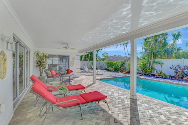 view of swimming pool with a patio and ceiling fan