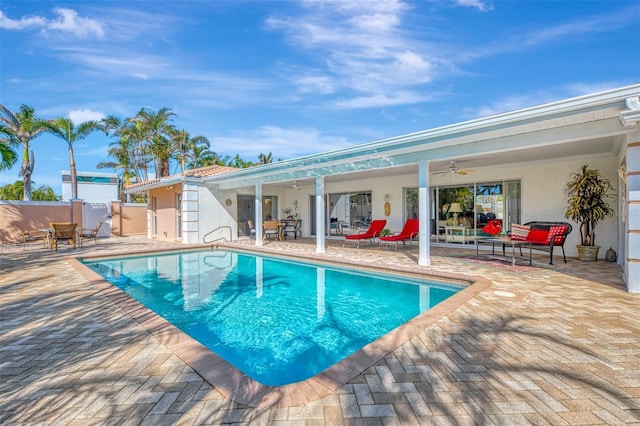 view of swimming pool with a patio, an outdoor hangout area, and ceiling fan