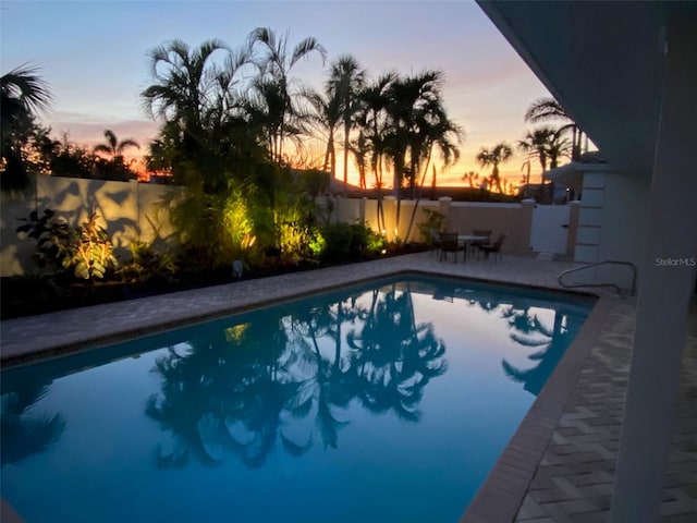 view of pool at dusk