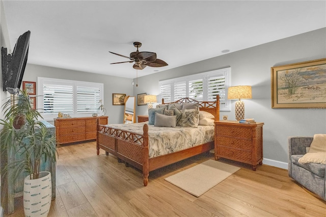 bedroom featuring multiple windows, ceiling fan, and light hardwood / wood-style floors