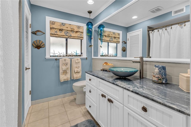 bathroom featuring ornamental molding, toilet, tile patterned floors, and vanity