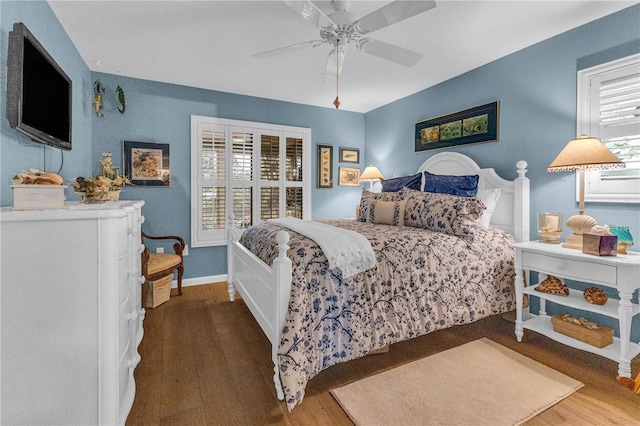 bedroom featuring multiple windows, hardwood / wood-style flooring, and ceiling fan