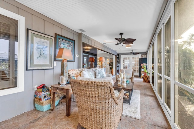 sunroom featuring a ceiling fan