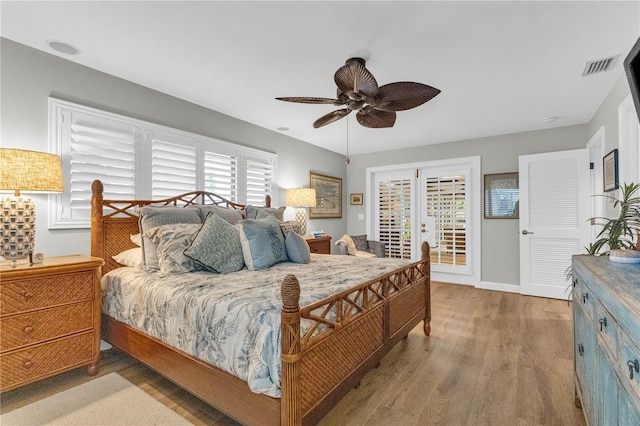 bedroom featuring baseboards, visible vents, a ceiling fan, wood finished floors, and access to outside