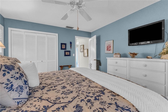 bedroom with a closet, visible vents, and a ceiling fan