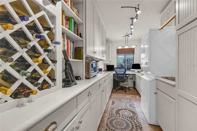 interior space with open shelves, built in desk, light countertops, and white cabinetry