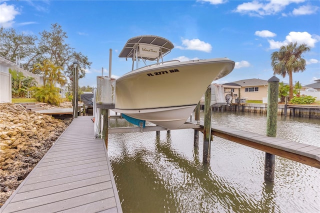 view of dock with a water view and boat lift