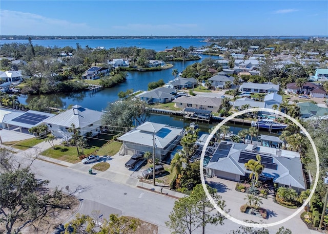 drone / aerial view featuring a residential view and a water view