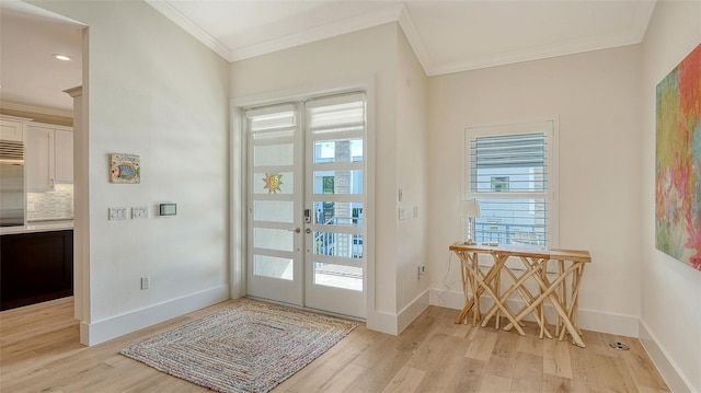 entryway featuring crown molding, light hardwood / wood-style flooring, and french doors