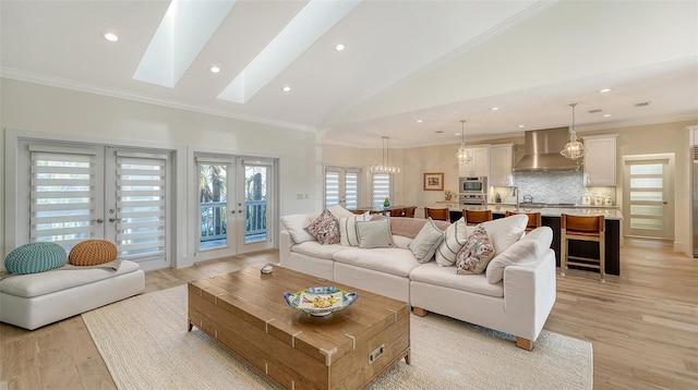 living room featuring crown molding, light hardwood / wood-style flooring, high vaulted ceiling, and french doors