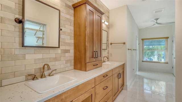 bathroom with vanity, ceiling fan, backsplash, and tile patterned floors