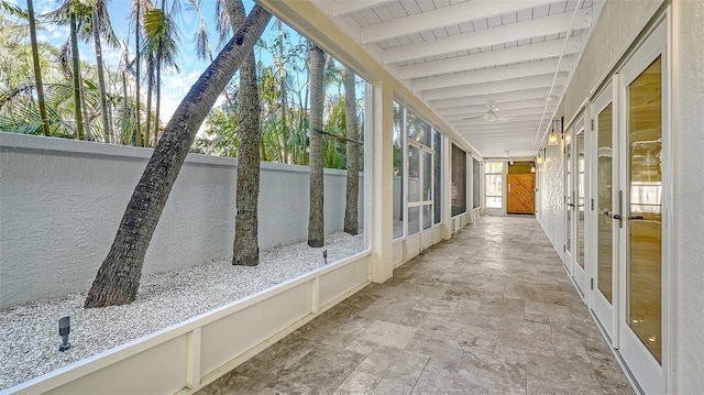 unfurnished sunroom featuring wood ceiling and beam ceiling