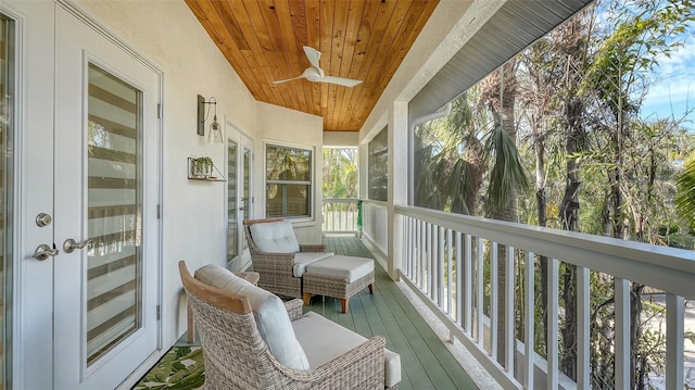 sunroom / solarium featuring wooden ceiling and ceiling fan