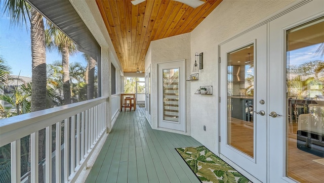 wooden terrace with ceiling fan and french doors