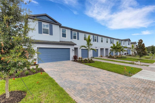 view of front of home with a garage and a front lawn