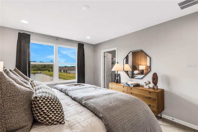 bedroom featuring a walk in closet and carpet floors