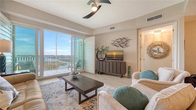 living room featuring light hardwood / wood-style floors and ceiling fan