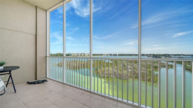 unfurnished sunroom with a water view