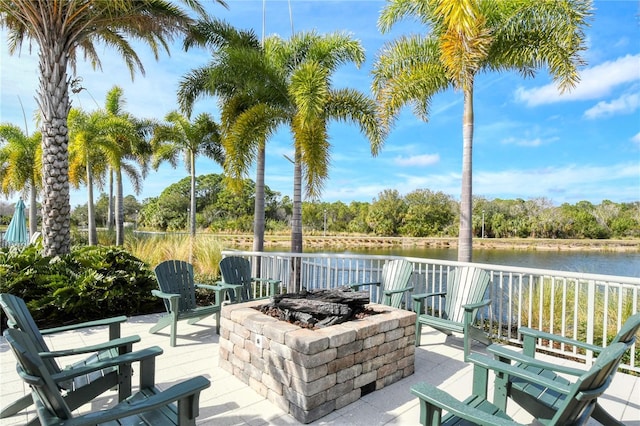 view of patio / terrace with a fire pit and a water view