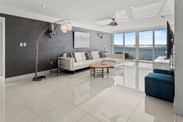 tiled living room with expansive windows, ceiling fan, and crown molding