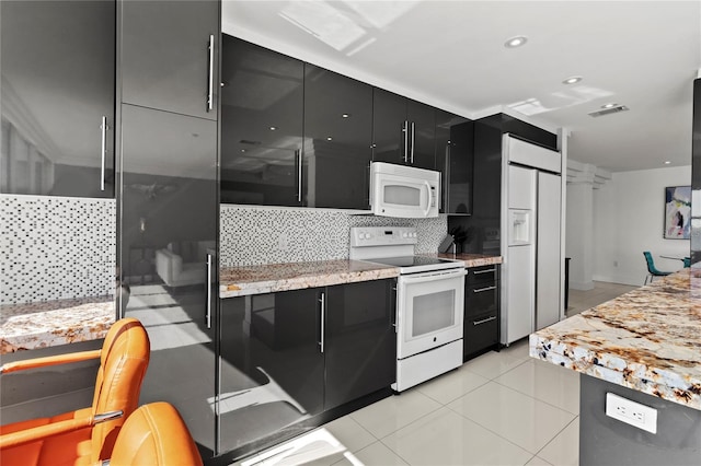 kitchen featuring white appliances, decorative backsplash, and light tile patterned flooring