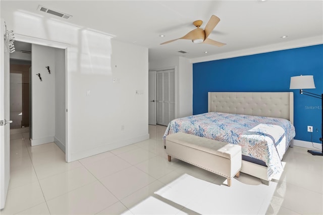 tiled bedroom featuring ceiling fan