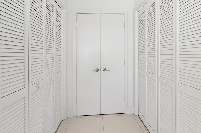 hall featuring light tile patterned floors