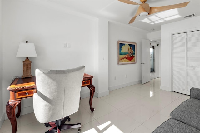 tiled office space with ceiling fan