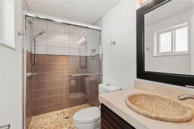 bathroom with walk in shower, vanity, and toilet