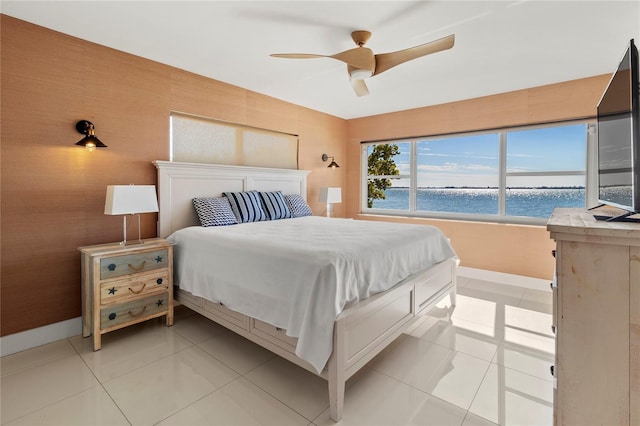 bedroom with ceiling fan and light tile patterned flooring