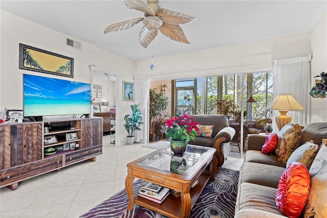 tiled living room featuring ceiling fan and a textured ceiling