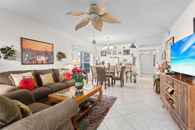 living room featuring ceiling fan with notable chandelier and a textured ceiling