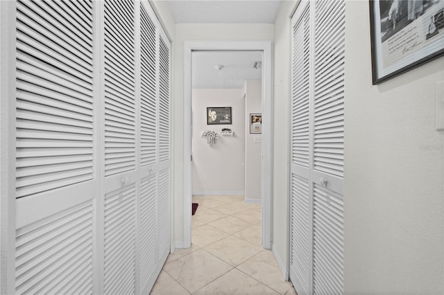 hallway featuring light tile patterned floors