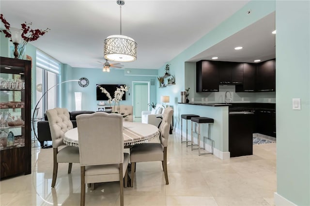 tiled dining space with sink and ceiling fan