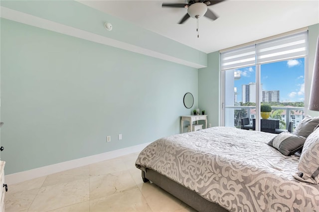 bedroom featuring ceiling fan, a wall of windows, and access to outside