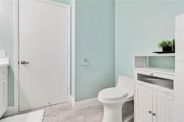 bathroom featuring tile patterned floors, vanity, and toilet