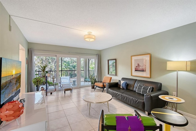 living room with light tile patterned floors and a textured ceiling