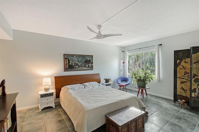 bedroom with a textured ceiling and ceiling fan