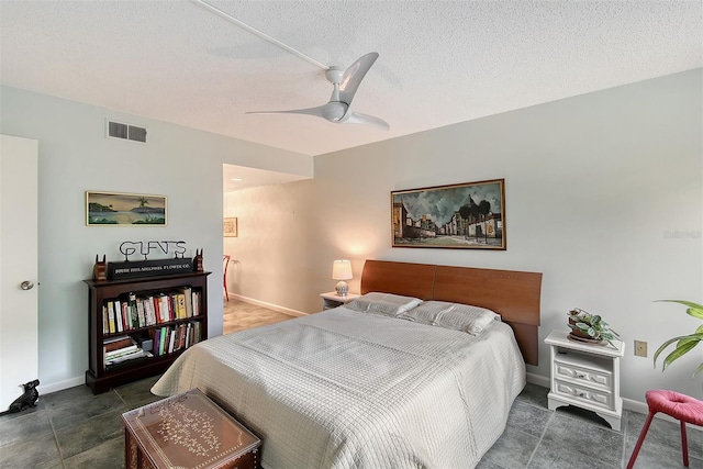 bedroom with a textured ceiling and ceiling fan