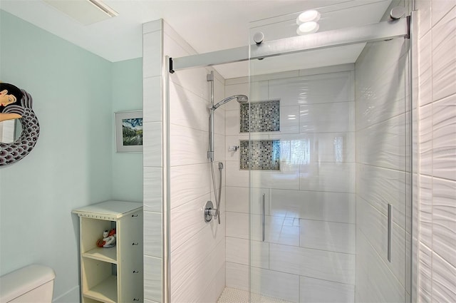 bathroom featuring an enclosed shower and toilet