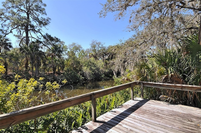 wooden terrace featuring a water view