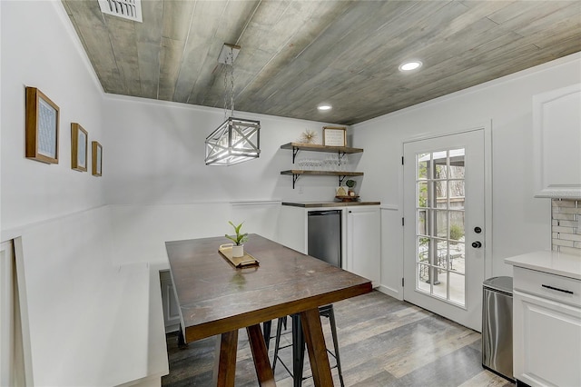 dining room with light hardwood / wood-style flooring and wooden ceiling