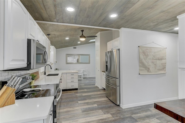 kitchen with white cabinetry, sink, stainless steel appliances, and wooden ceiling