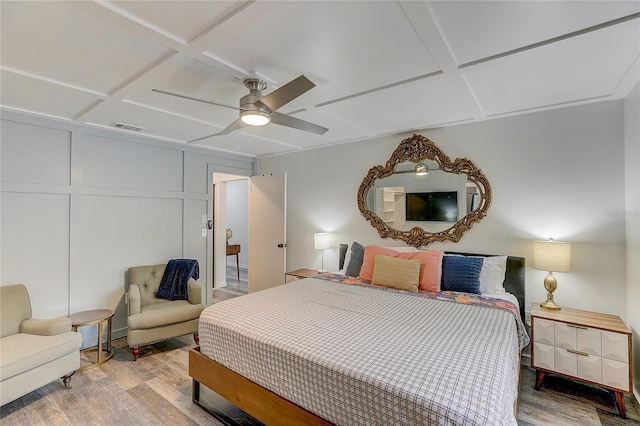 bedroom with wood-type flooring, coffered ceiling, and ceiling fan