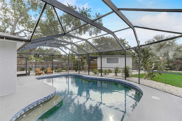 view of swimming pool featuring a patio area and glass enclosure