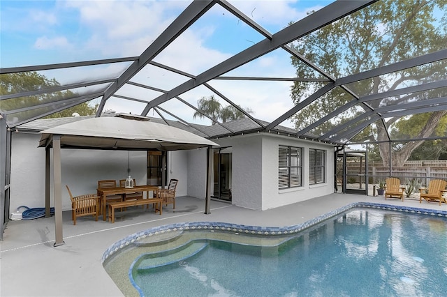 view of swimming pool with a lanai and a patio area