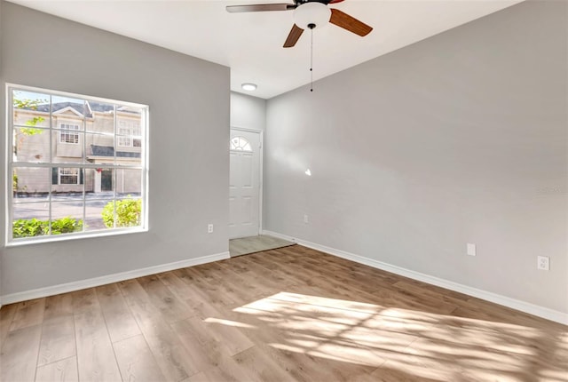 spare room featuring light hardwood / wood-style floors and ceiling fan