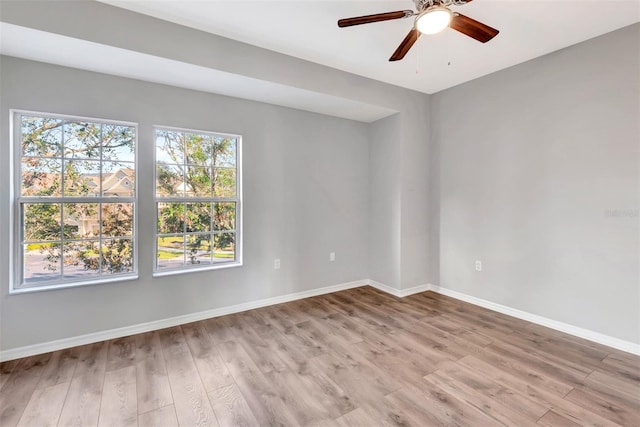 spare room featuring ceiling fan and light hardwood / wood-style flooring