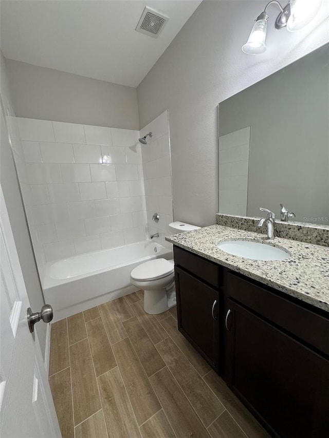 full bathroom with shower / tub combination, vanity, and toilet