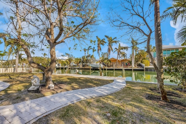 view of community featuring a water view and a yard